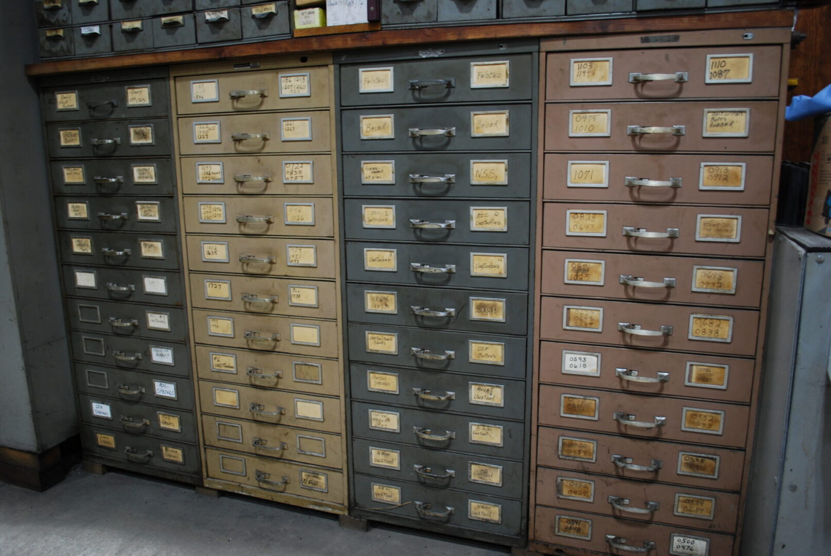 Vintage metal cabinet with labeled drawers