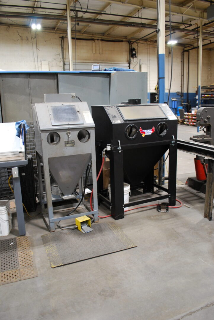 Two industrial sandblasting cabinets in workshop