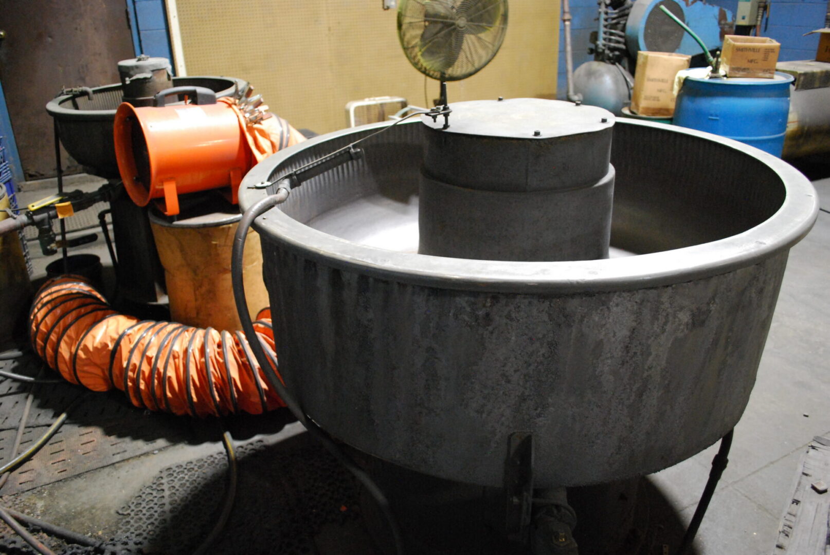 Large round industrial metal vat in workshop
