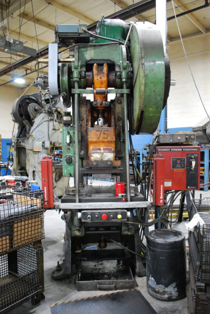 Green industrial punch press in factory