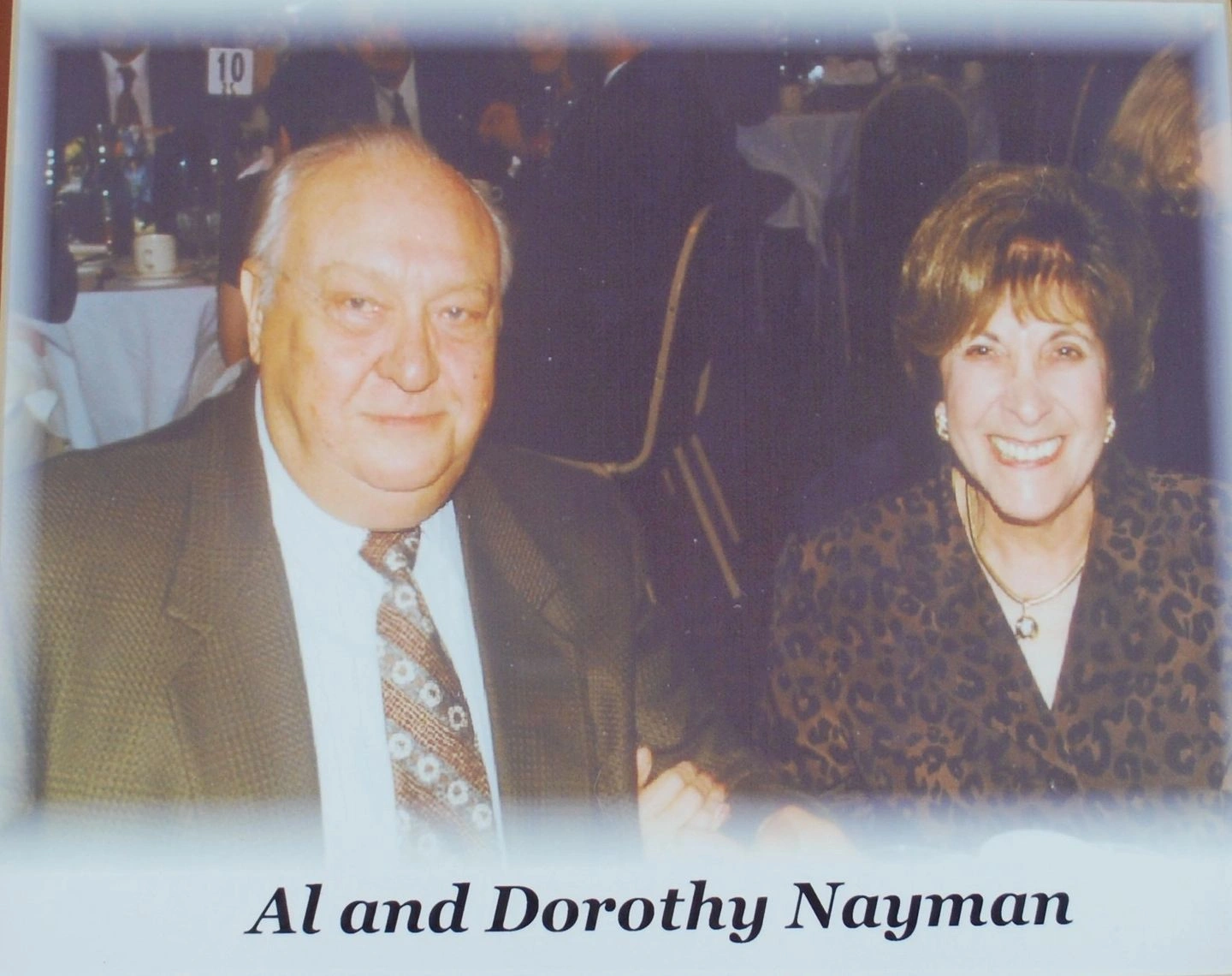Smiling elderly couple at formal dinner